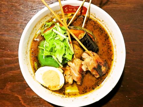 Soup curry (スープカレー) is a light curry flavored soup served with some type of meat, and a rainbow of roasted vegetables. スープカレー編「soup curry & dining Suage＋(すあげプラス)/パリパリ知床鶏と野菜カレー」 | 札幌ラーメンブログ