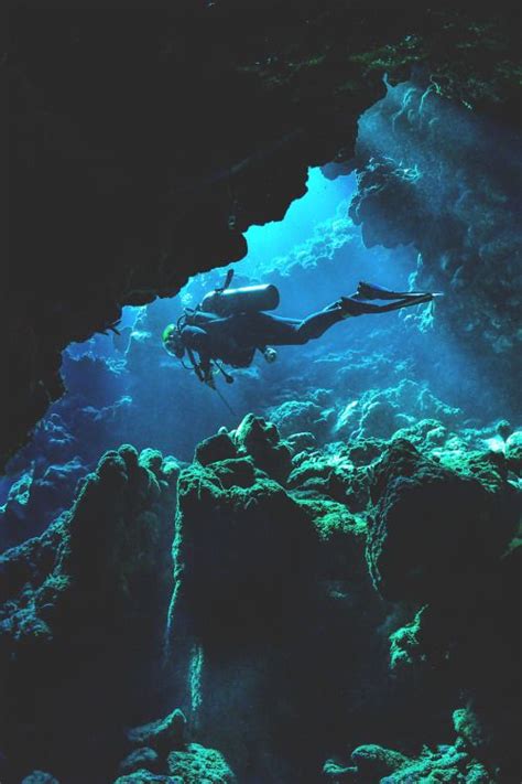 A Person Swimming In An Underwater Cave
