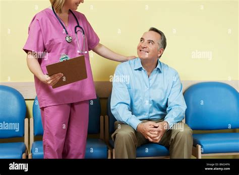Female Nurse Talking To A Patient In The Waiting Room Stock Photo Alamy