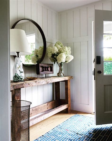 Gorgeous Entryway With A Round Mirror Above A Console Table Farm