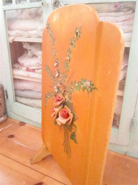 An Orange Chair With Flowers Painted On It