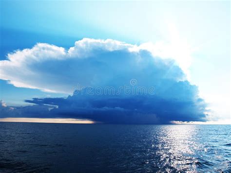 Bright Blue Sky With Stormy Clouds Over A Sea Stock Image Image Of