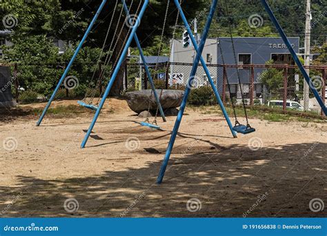 A Swing Set With All Of The Swings In Motion Editorial Stock Photo