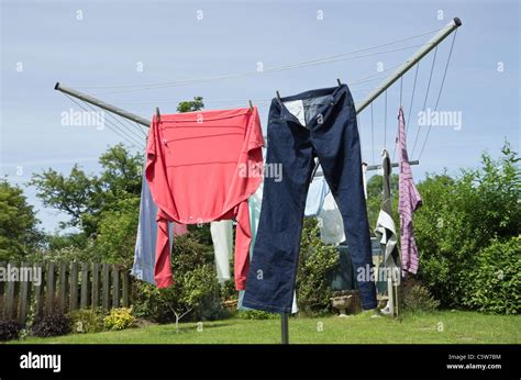 Household Wet Clothes Hanging On A Rotary Washing Line To Dry Stock