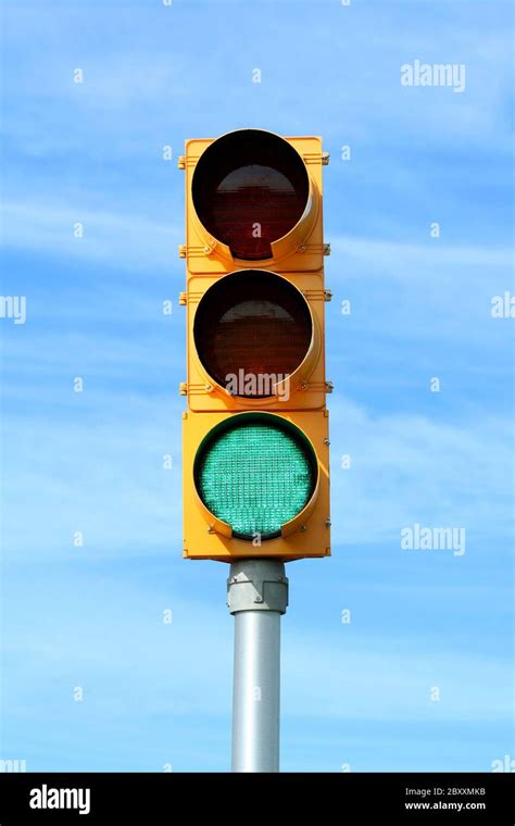 Green Traffic Signal Light Against Blue Sky Stock Photo Alamy