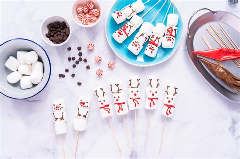 Premium Photo Flat Lay Making Marshmallow Snowmen And Reindeer On Sticks For Hot Chocolate