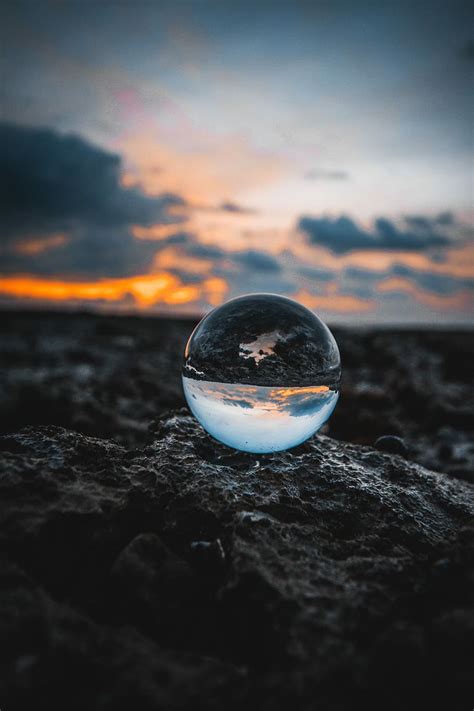 Hd Wallpaper Marble Toy Mirror Ball On Stone During Golden Hour