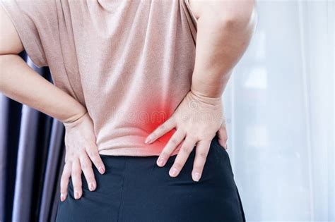 Woman With Lower Back Pain Muscle Strain And Spasms Due To Prolonged
