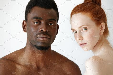 Black Man And White Girl - Close up shot of black male and white female posing isolated against