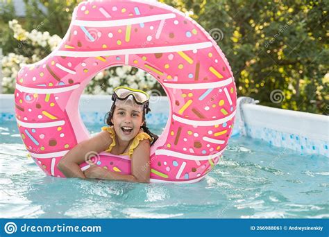 Girl Plays An Inflatable Ring Is In Swimming Pool In The Garden Stock Image Image Of Play