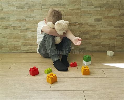 Little Sad Boy Sitting On The Floor With A Block Depression Frustrated