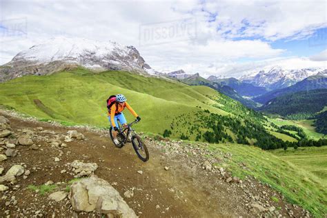 Young Woman Mountain Biking In The Dolomite Mountains Val Gardena