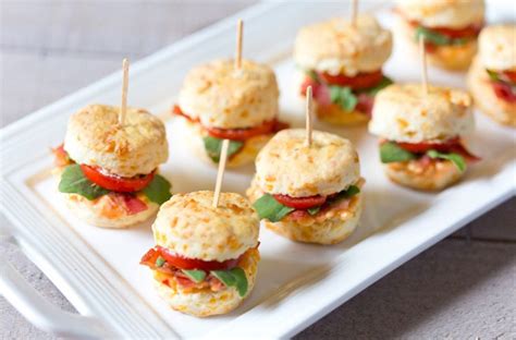 Mini Cheddar Biscuits On A Plate With Toothpicks In Them