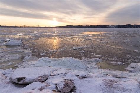 Ice Melting On The St Lawrence River During A Hazy Late Winter Sunrise