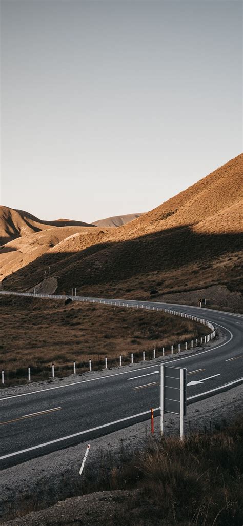 Gray Asphalt Road Between Brown Mountains During D Iphone X