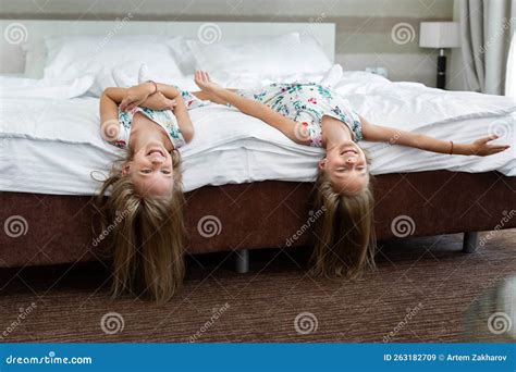 two twin sisters are lying on the bed upside down stock image image of little cheerful 263182709