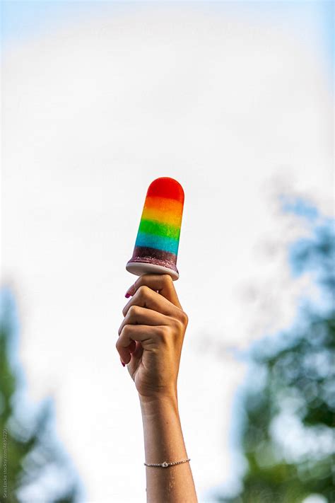 Woman Holds Up Pride Rainbow Popsicle Del Colaborador De Stocksy