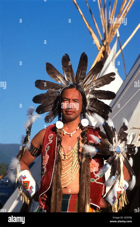 Native American Man Wearing Ceremonial Dress In Front Of Teepee Usa