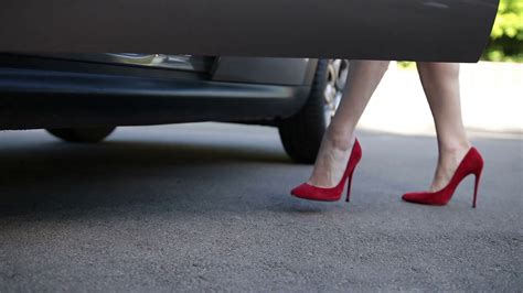 Elegant Female Legs In Red Heels Getting Into Car Stock Video Footage