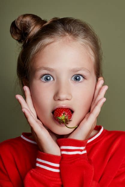 Premium Photo Young Girl Eats Strawberries Cheerful Emotions