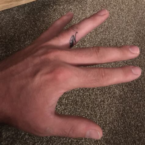 Initial Ring Finger Tattoo