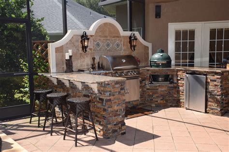 Big green eggs are popular and full disclosure: Outdoor kitchen with Big Green Egg, gas grill and bar seating.