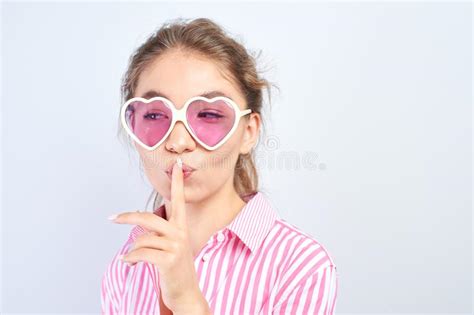 asian kazakh girl put her index finger to lips shh concept keep quiet secret silence stock