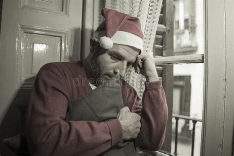 Dramatic Lifestyle Portrait Of Sad And Depressed Man In Santa Claus Hat