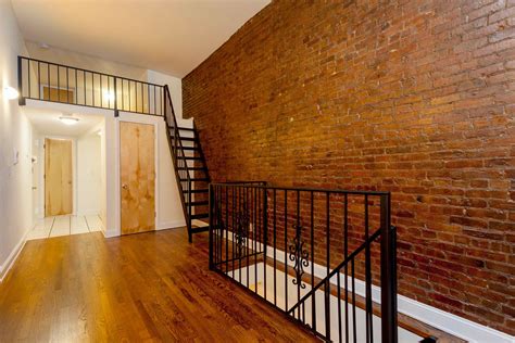 Interior Of Apartment Exposed Brick Wall And Hardwood Floors 112 120