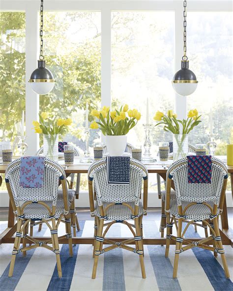 Bold patterns in striking blues and vivid corals pack a colorful punch in this dining room, which seamlessly blends super traditional pieces, like the stately table and mirrored console, with groovier pieces, like the chippendale chairs and an artfully marbled lamp. Where to find the best woven bistro chairs — Coastal ...