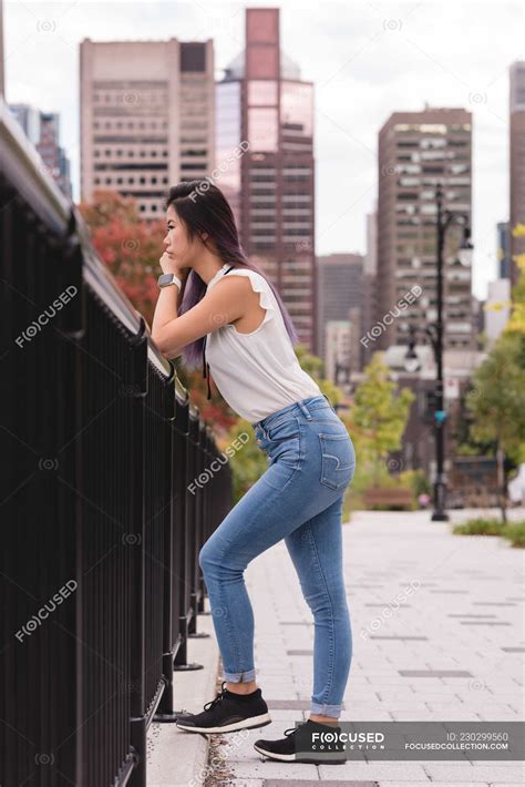 Side View Of Woman Leaning On Railing On A Sunny Day Modern Pretty