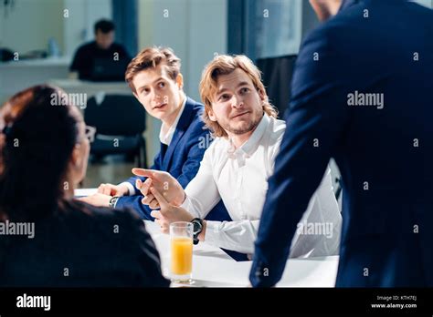 Businessman Presenting To Colleagues At Meeting Stock Photo Alamy