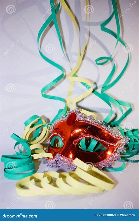 Red Carnival Mask With Colorful Paper Streamers For Party Celebration