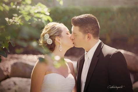 The Bride And Groom Share Their First Kiss Of The Day On Their Wedding