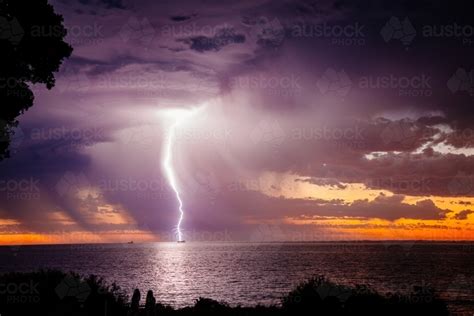 Image Of Sunset Lightning Bolt And Stormy Sky Over The