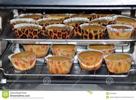 Test for doneness at nine minutes by inserting a toothpick or cake tester into a cupcake, then remove it. Cupcakes baking in oven stock image. Image of food ...