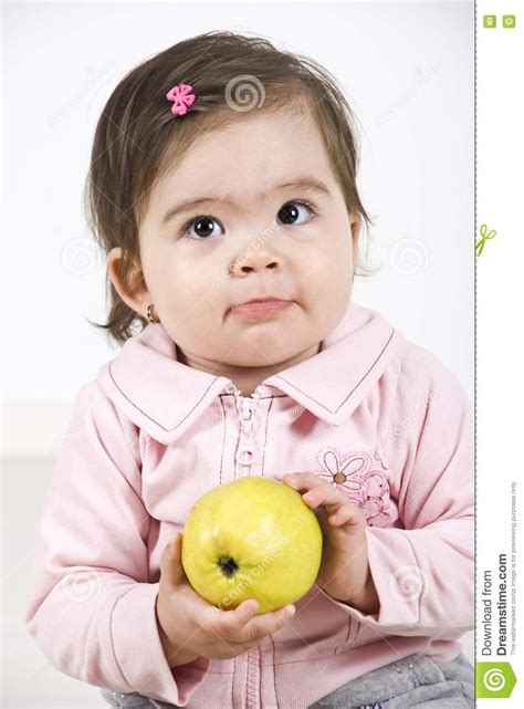 Sulky Baby Holding An Apple Stock Photo Image Of Child Attentive