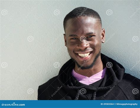 Close Up Portrait Of A Cheerful Young Black Man Smiling Stock Photo