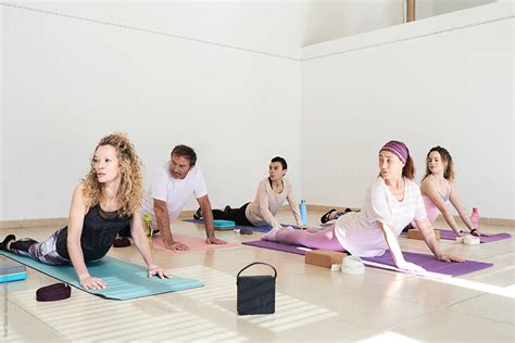Group Yoga Class Diverse Ages By Stocksy Contributor Ivan Gener