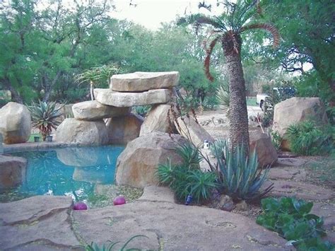 The rock terraces and pond both store daytime heat and release it during the cool colorado nights, which aids plant growth and fruit production. Artificial Rock pool by Designer Gardens Landscaping www ...