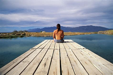 A Man Sitting At The End Of A Dock Photograph By Corey Rich Fine Art