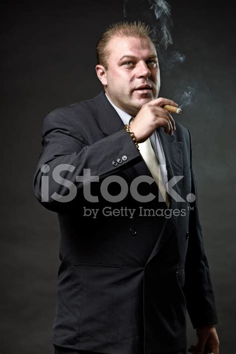 Gangster Mafia Man In Suit With Tie Smoking A Cigar Stock Photos