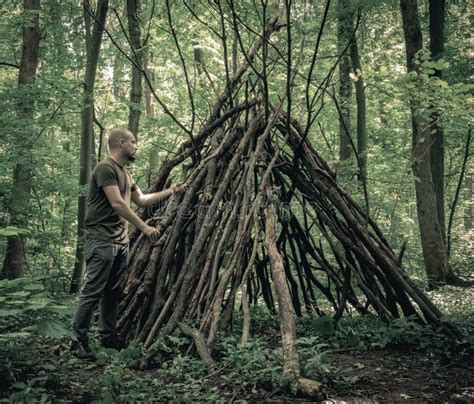 Man Building A Survival Shelter In The Forest Shelter In The Woods