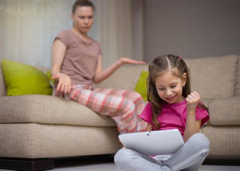 Mother Frustrating That Her Daughter Playing Video Games Stock Photo