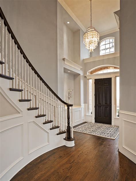 Modern loft stairs with office underneath. Traditional Gray Foyer With Spiral Staircase and Wall ...