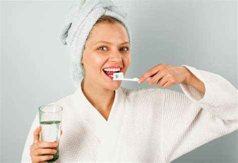 Premium Photo Smiling Woman Brushing Teeth In Bathroom Morning Happy