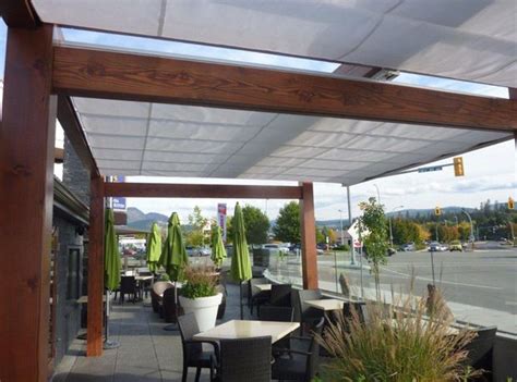 Easy to install with clamps that connect to the tent legs. Cantilever Retractable Canopies at Ora Restaurant in ...