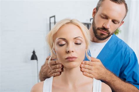 Portrait Of Massage Therapist Massaging Neck Of Young Woman Stock Image Image Of Indoors