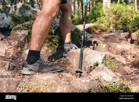 Man Climbs In Sneakers In Outdoor Action Top View Of Hiking Boot On