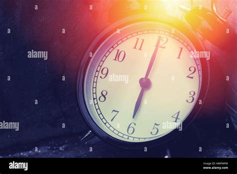 6 Oclock Vintage Clock At Dark Color Tone With Sun Light Memory Time